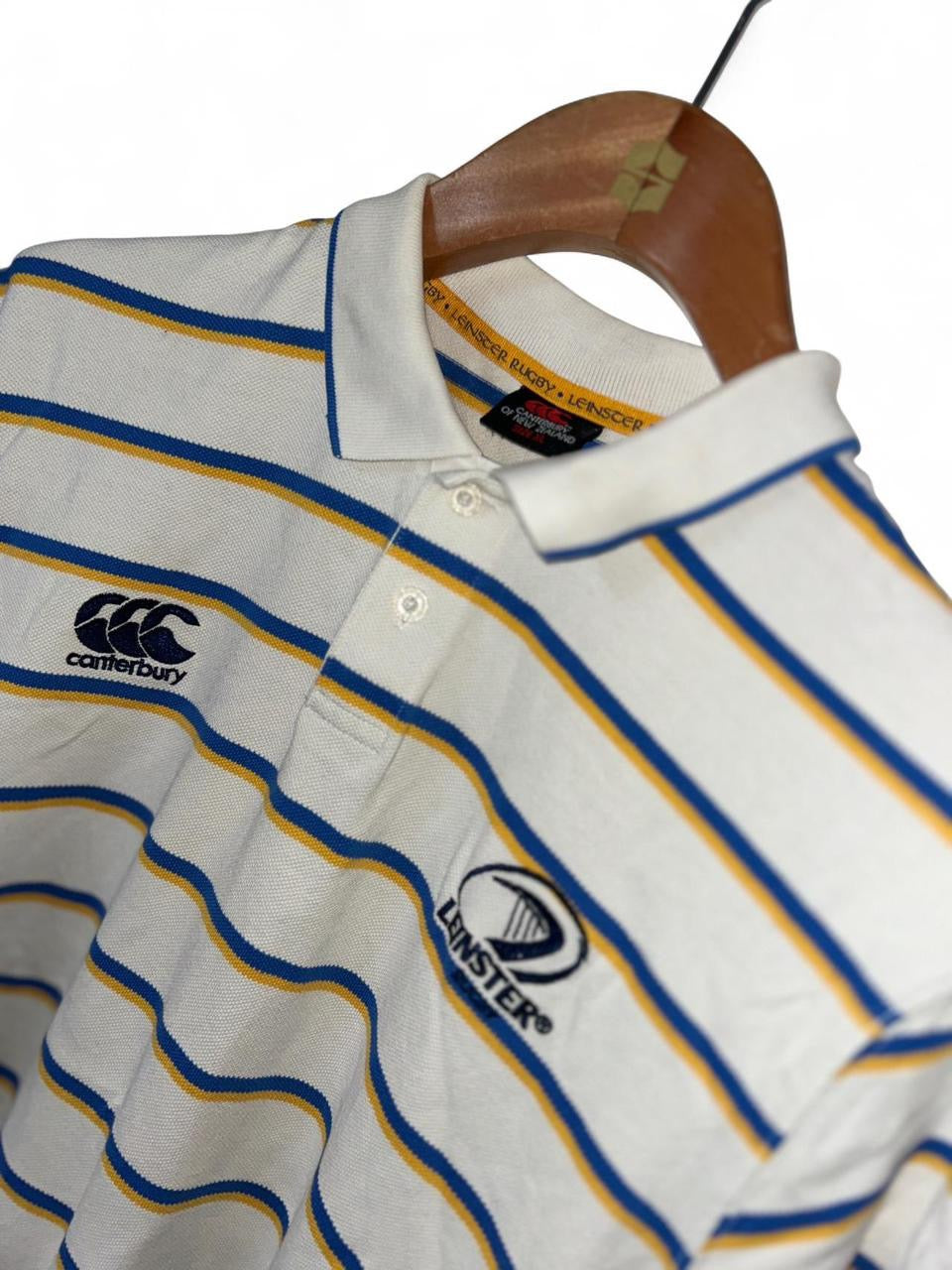 Canterbury Leinster Rugby Polo Shirt in white with blue and yellow stripes
 #rugby
Size xl 
L 30 w 22
SKU 7156