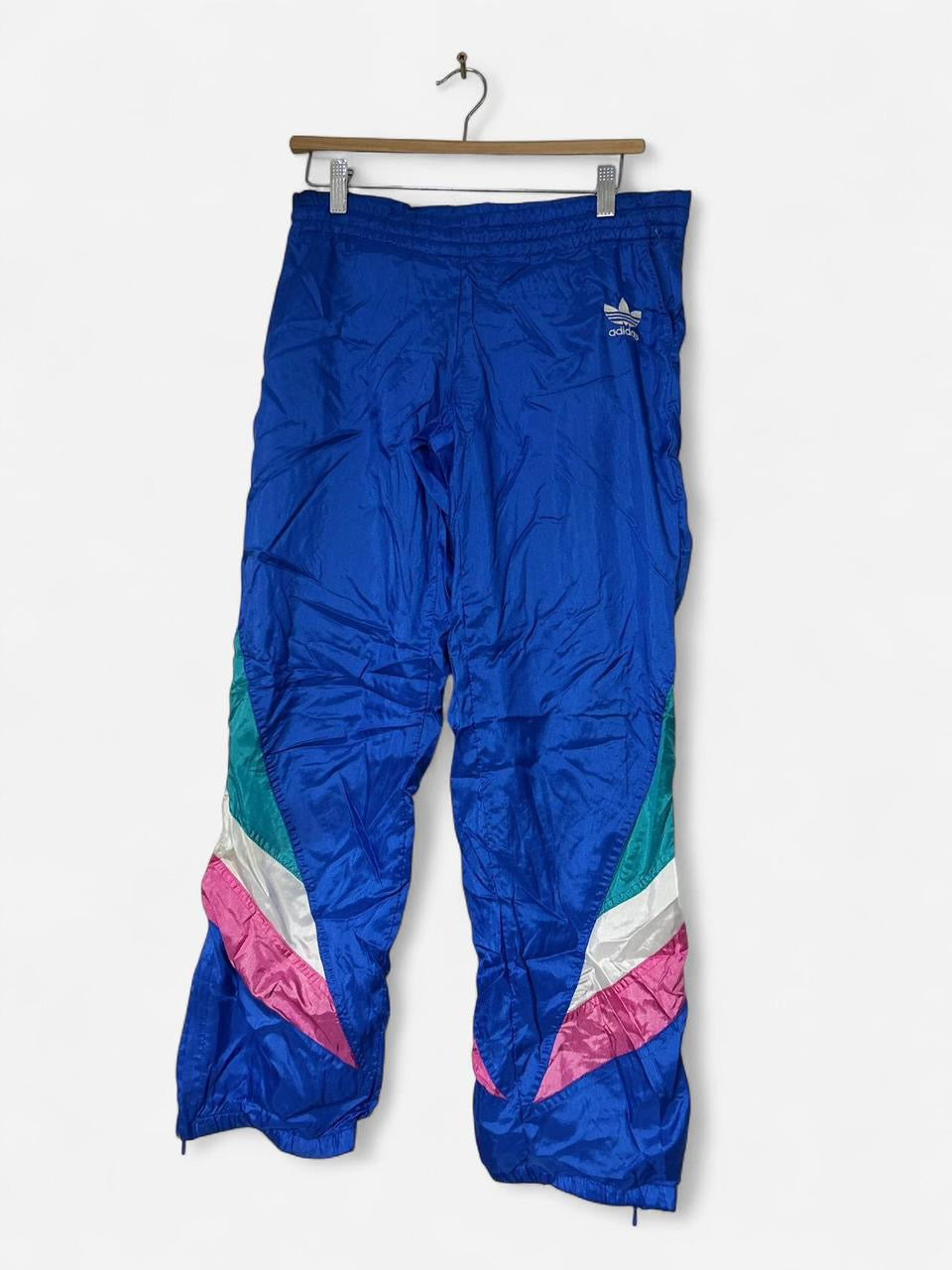 Blue Adidas track pants with drawstring waist, zipper pockets and elasticated ankles adidas #trackpants