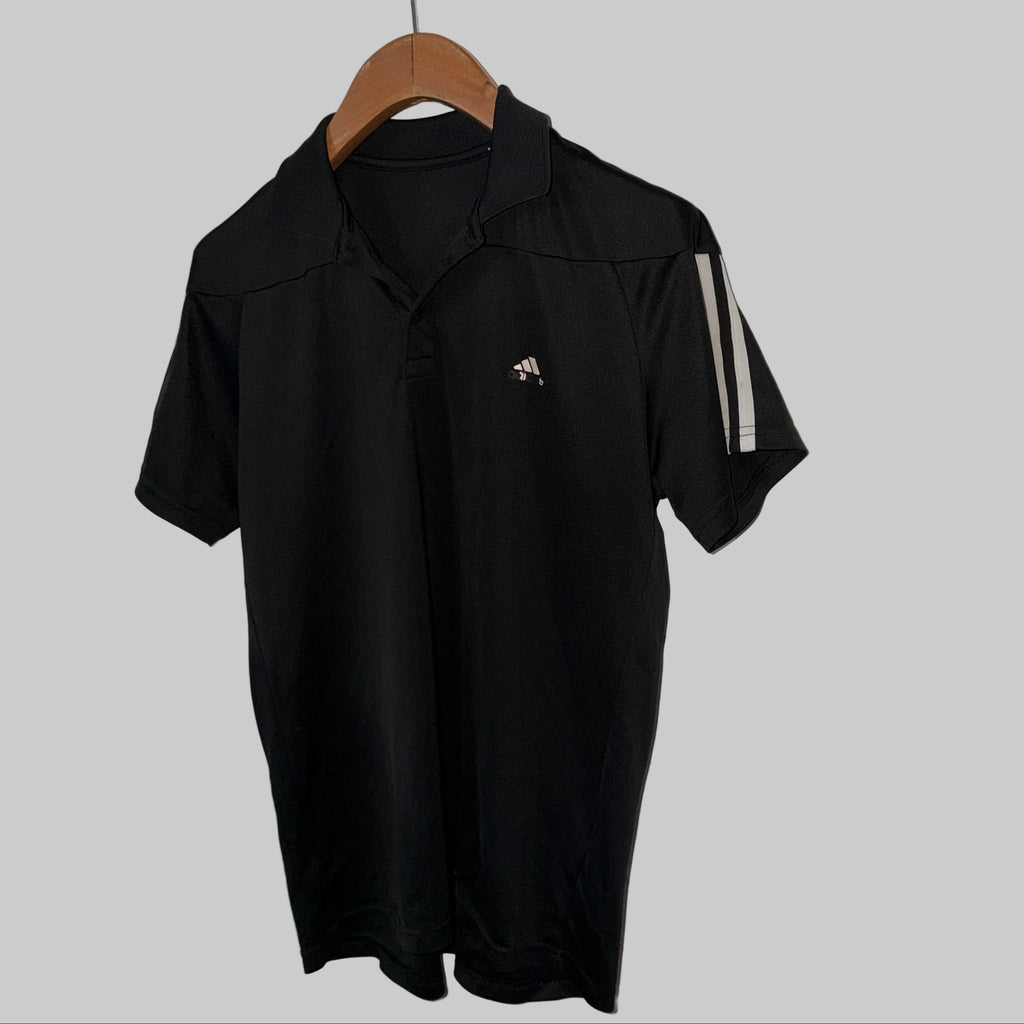 Adidas-branded black polo shirt with Climalite technology and shoulder stripes, similar to the Adidas Men’s Fab Polo Shirt. 

