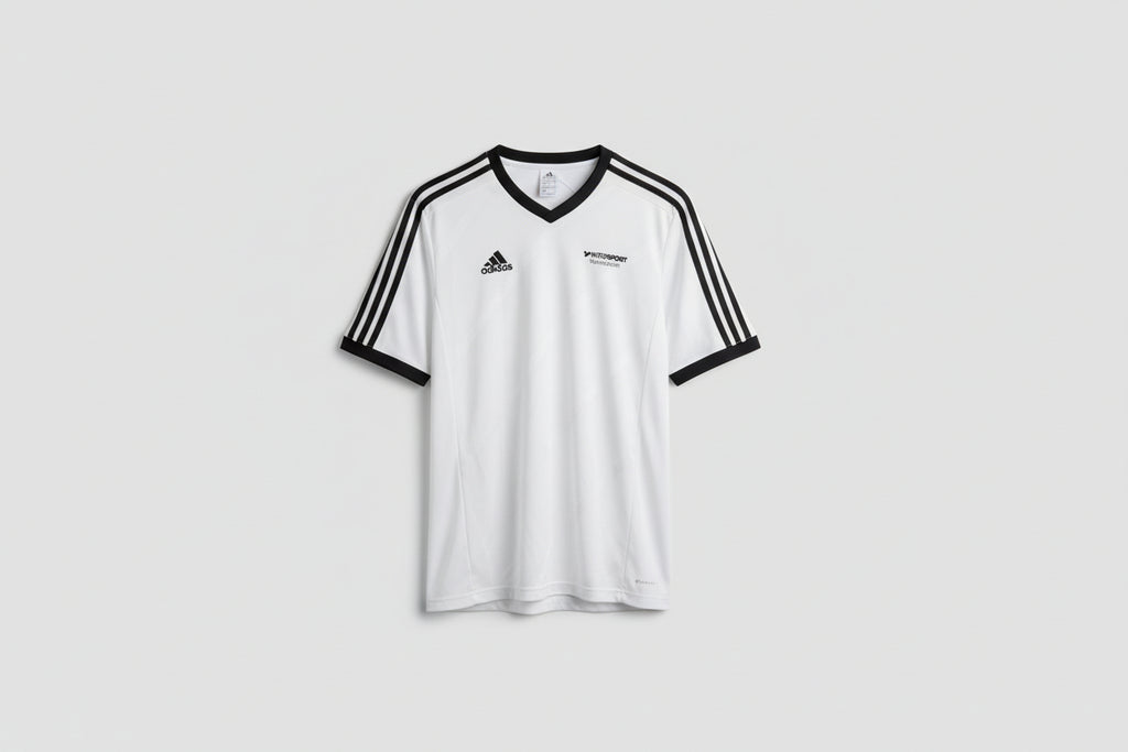 White sports jersey with black accents on a hanger against a white wall.