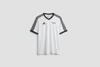 White sports jersey with black accents on a hanger against a white wall.