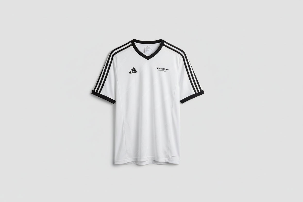 White sports jersey with black accents on a hanger against a white wall.