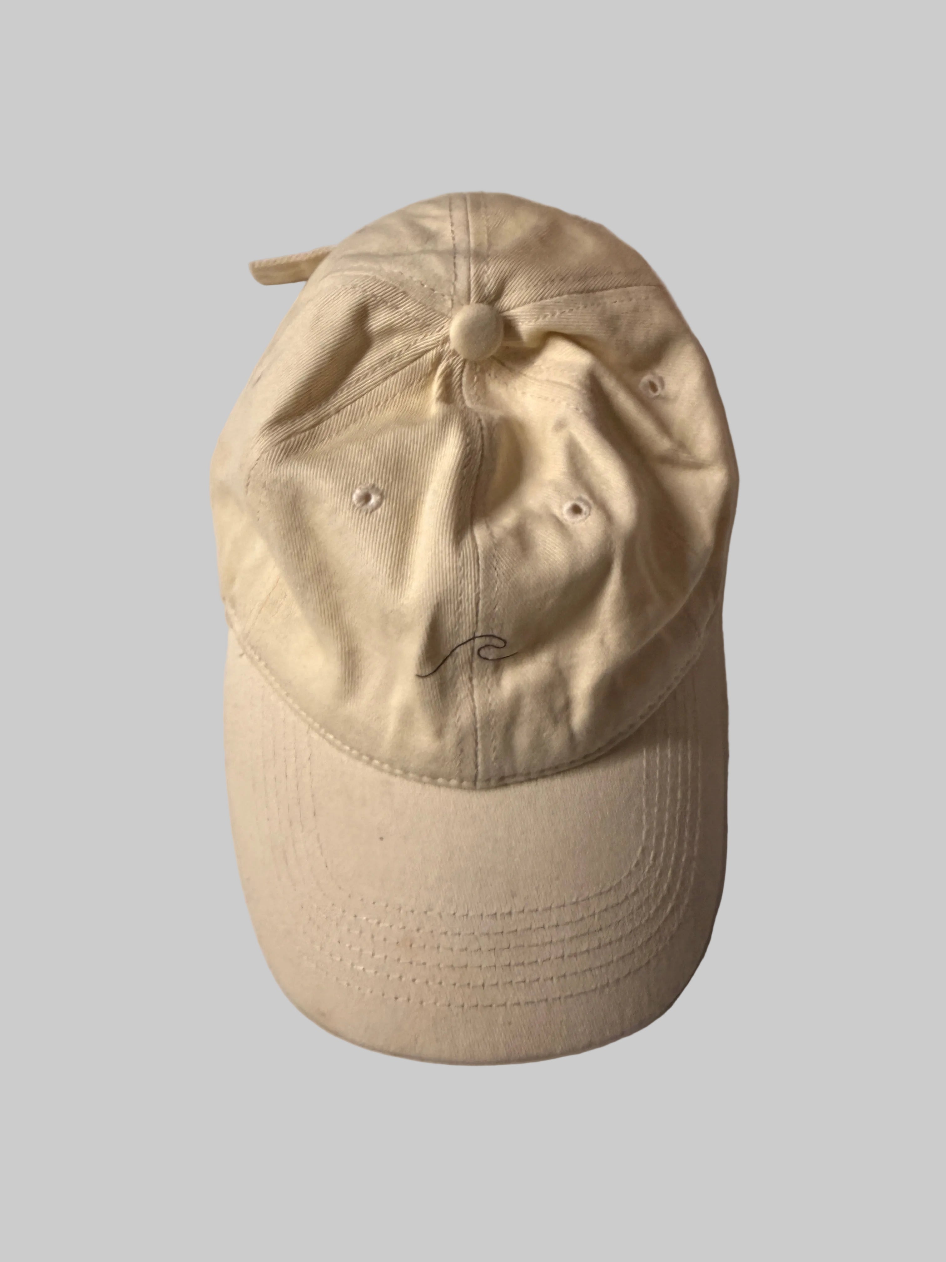 Beige cap on a white surface