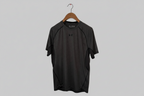 Black t-shirt on a hanger against a gray background