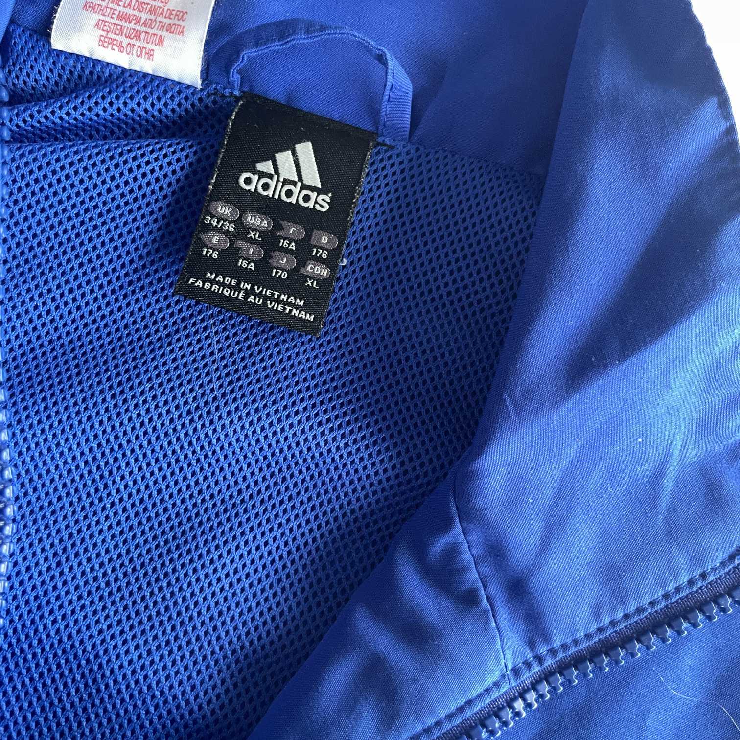 Vintage men Adidas blue full zip wind breaker track jacket in M/L|L30W21|SKU 5718