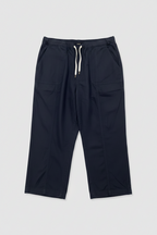 A pair of dark navy blue cropped pants with an elastic drawstring waist and large side pockets, laid flat on a white background.