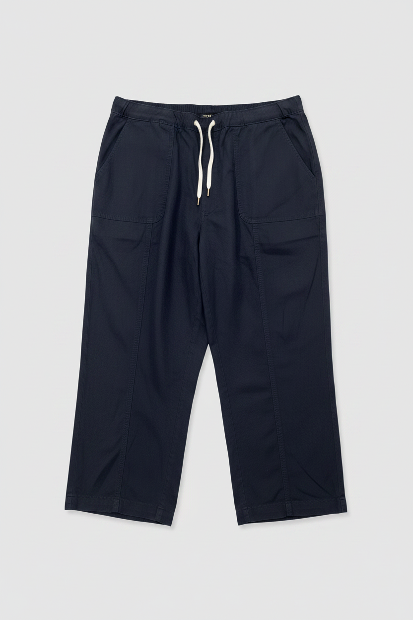 A pair of dark navy blue cropped pants with an elastic drawstring waist and large side pockets, laid flat on a white background.