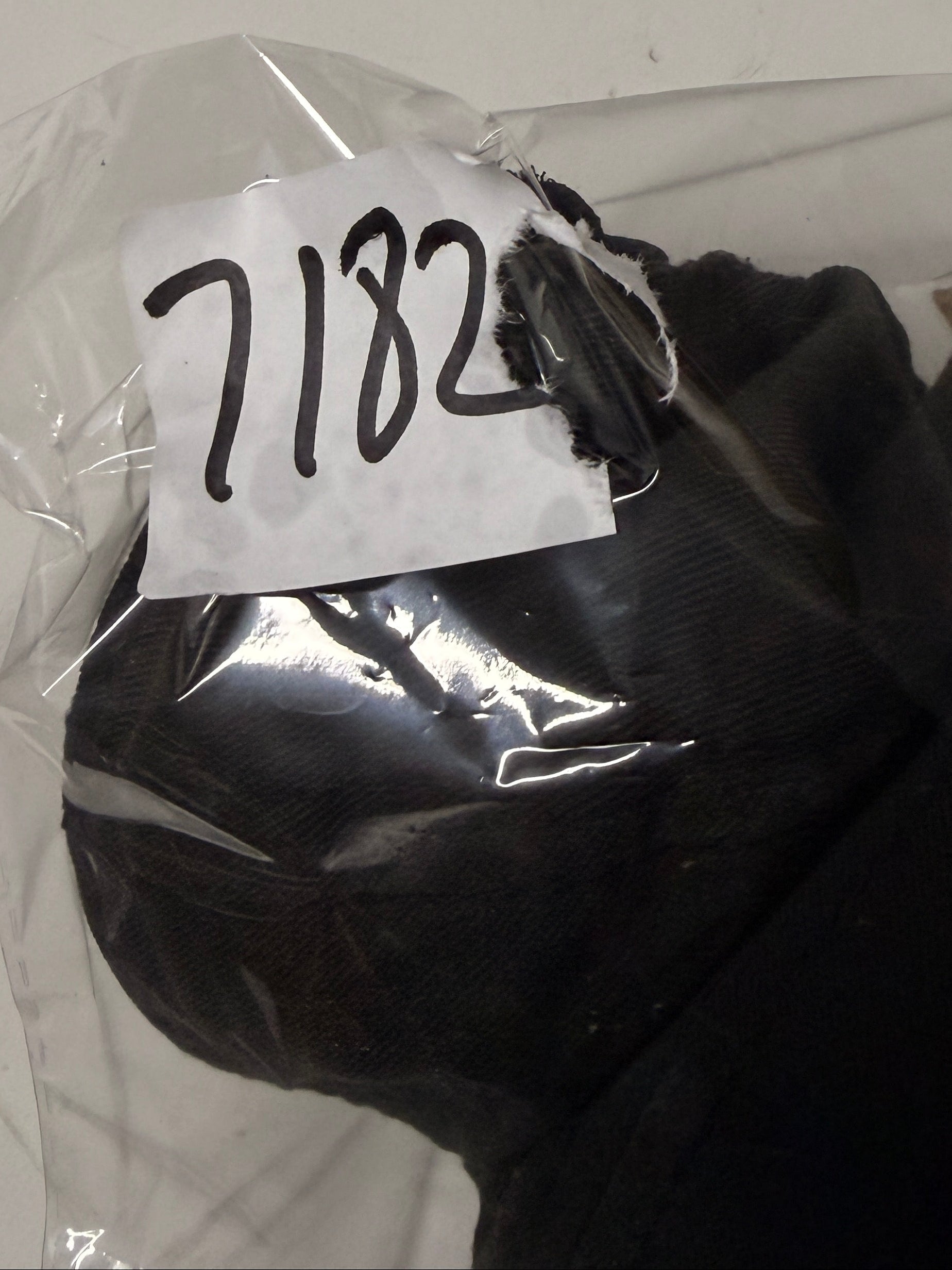 Black glove with a white label on a white background