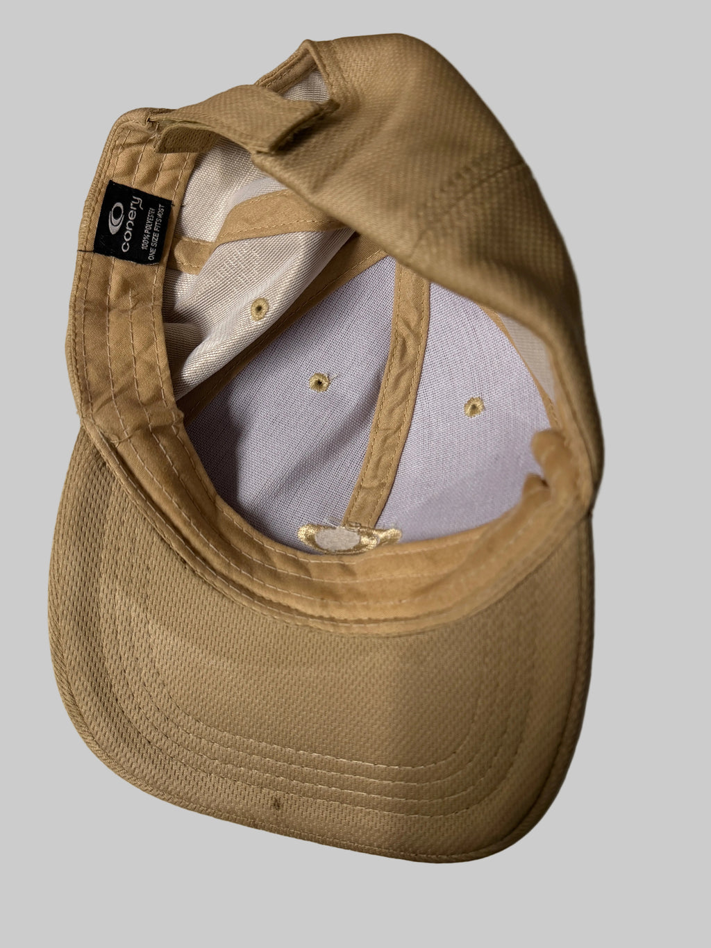 Beige cap with a brand logo on a white background