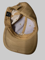 Beige cap with a brand logo on a white background