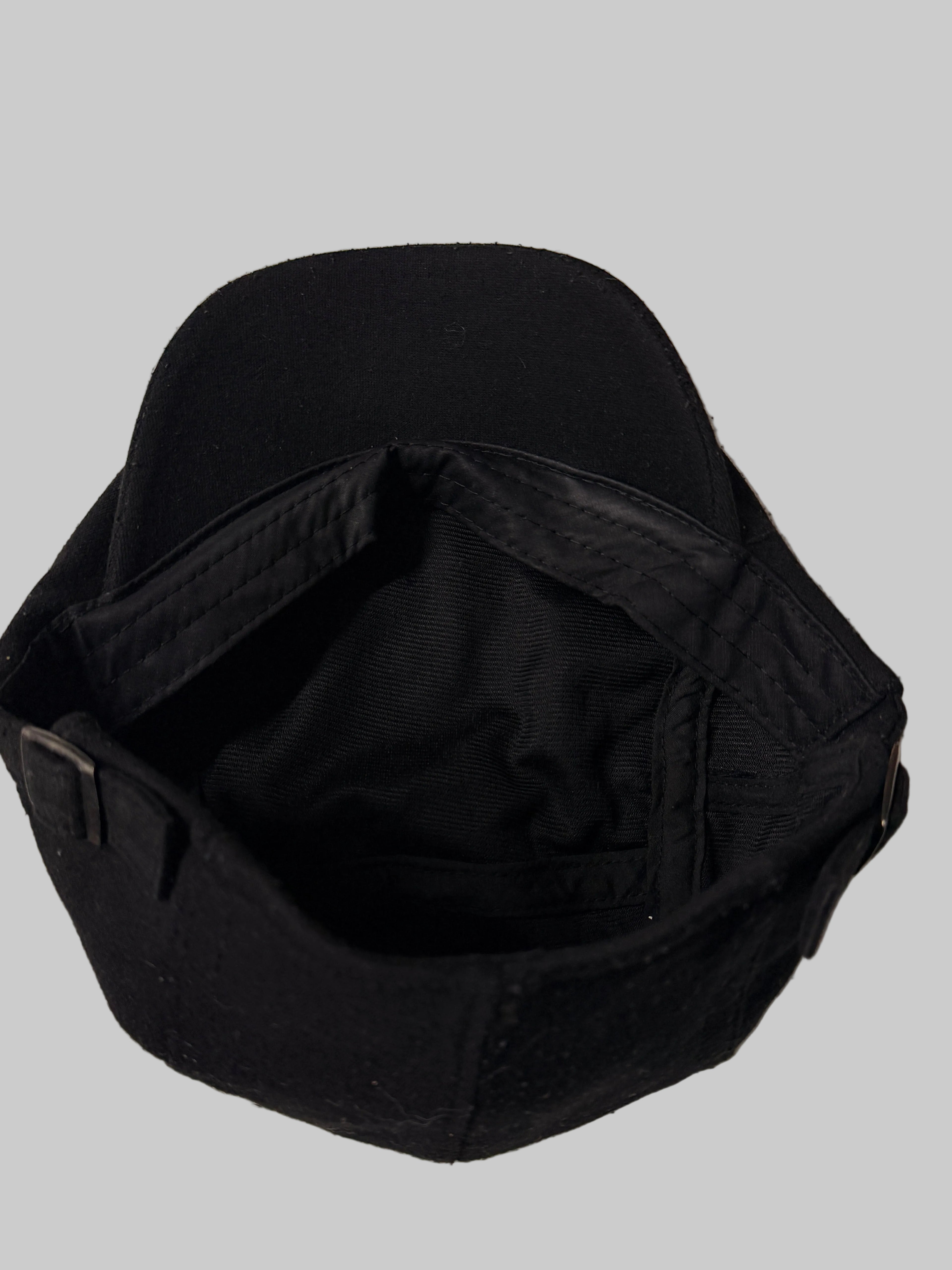 Black cap on a white surface