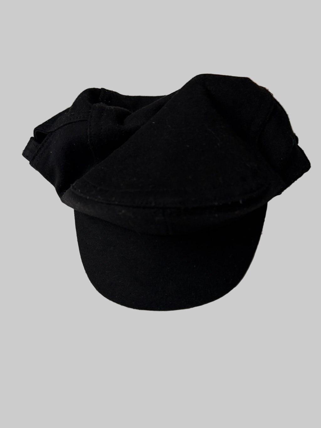 Black cap on a light-colored surface