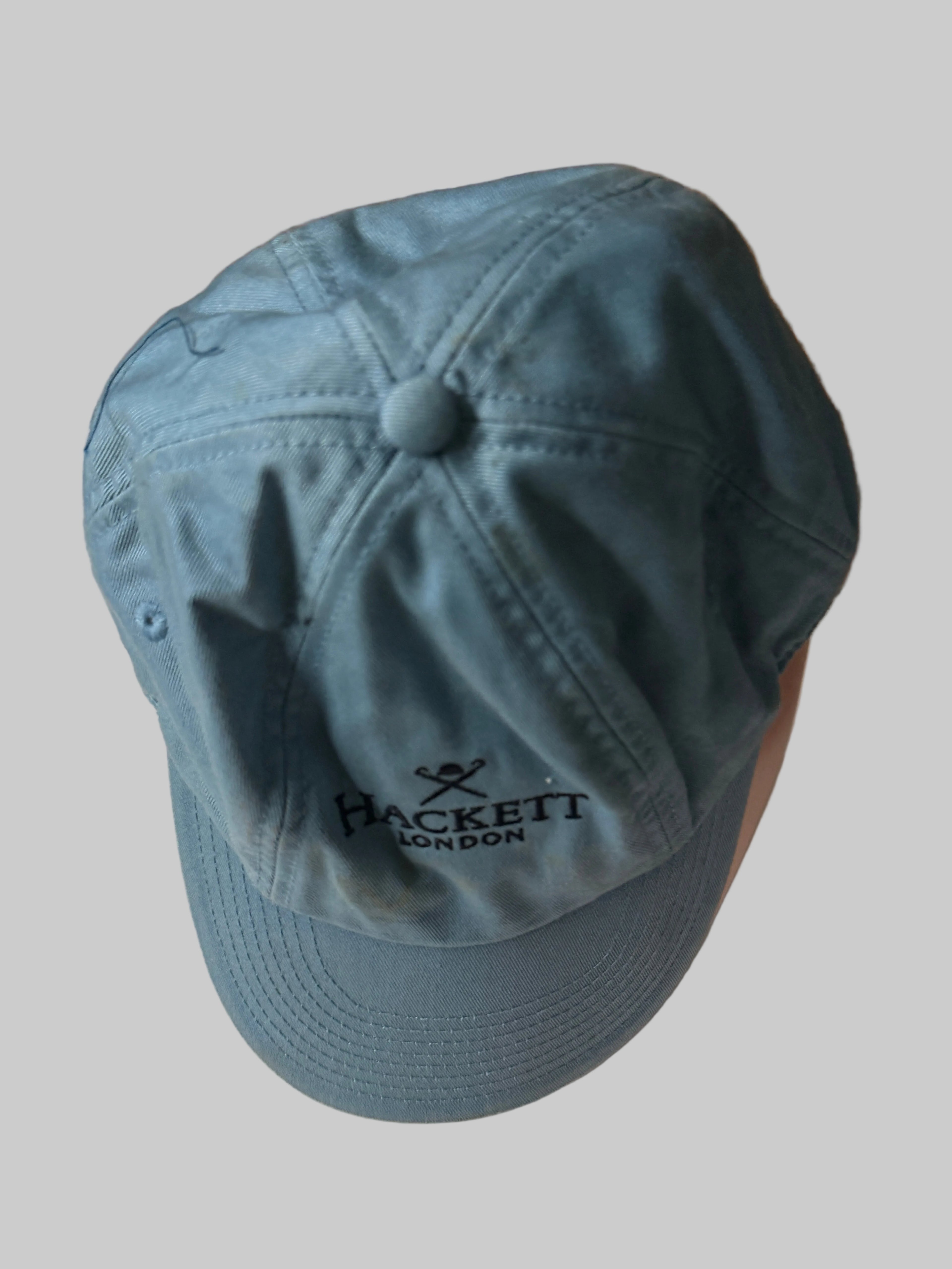Blue cap with a brand logo on a white surface