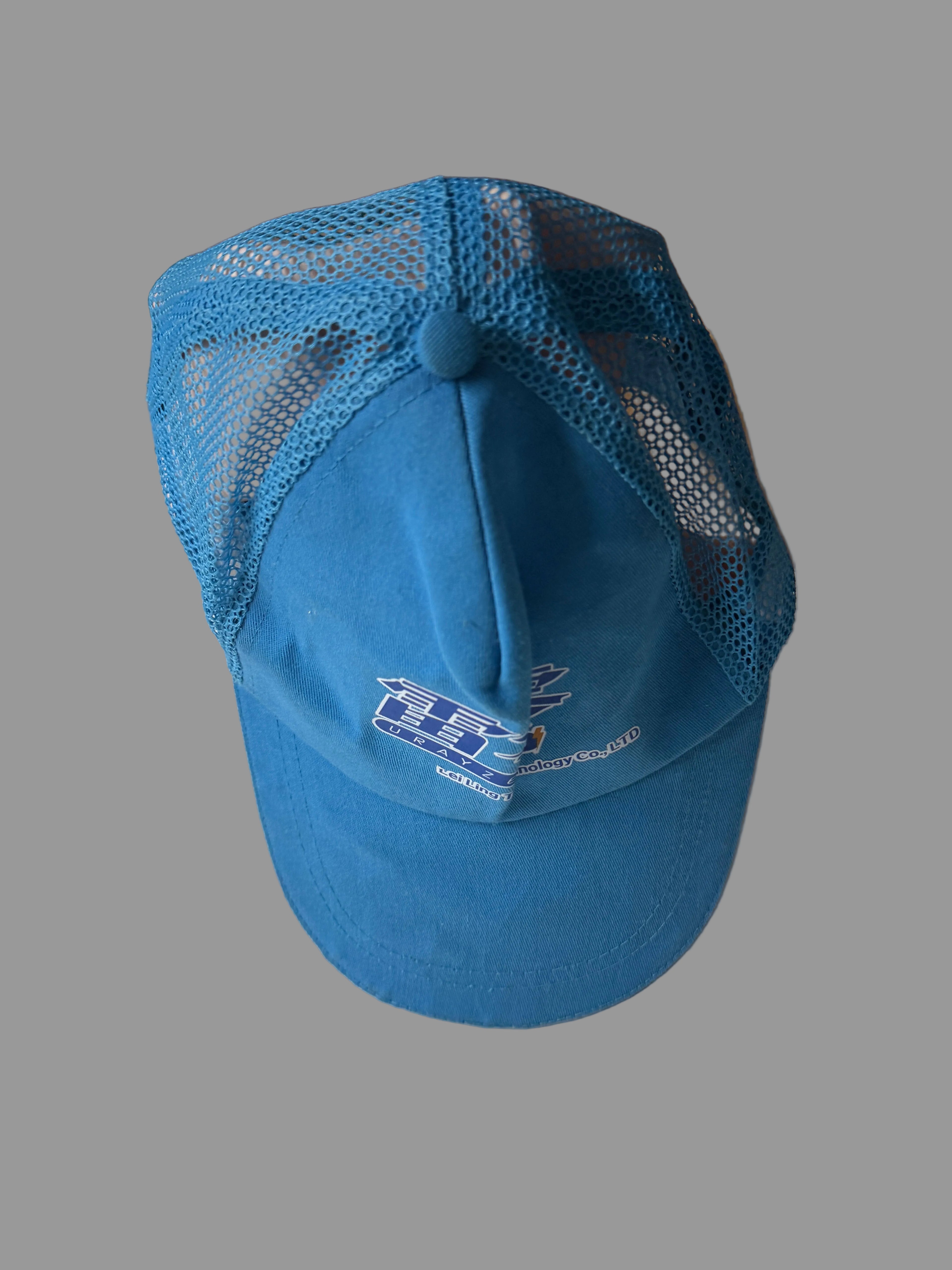 Blue cap with mesh back on a white surface