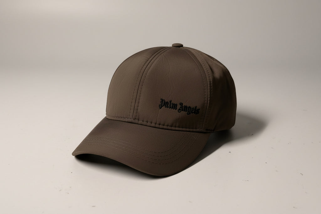 Brown cap with a brand logo on a light beige background