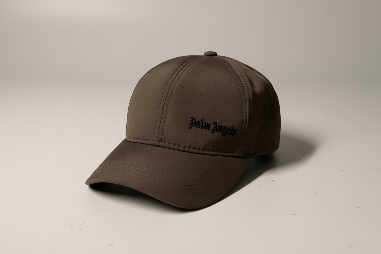 Brown cap with a brand logo on a light beige background