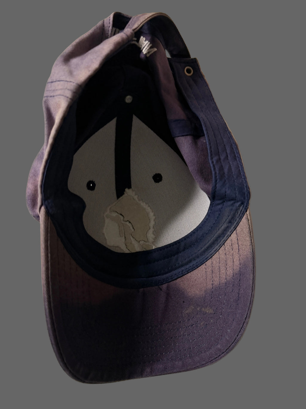 Blue baseball cap with a logo on a white background