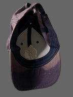 Blue baseball cap with a logo on a white background