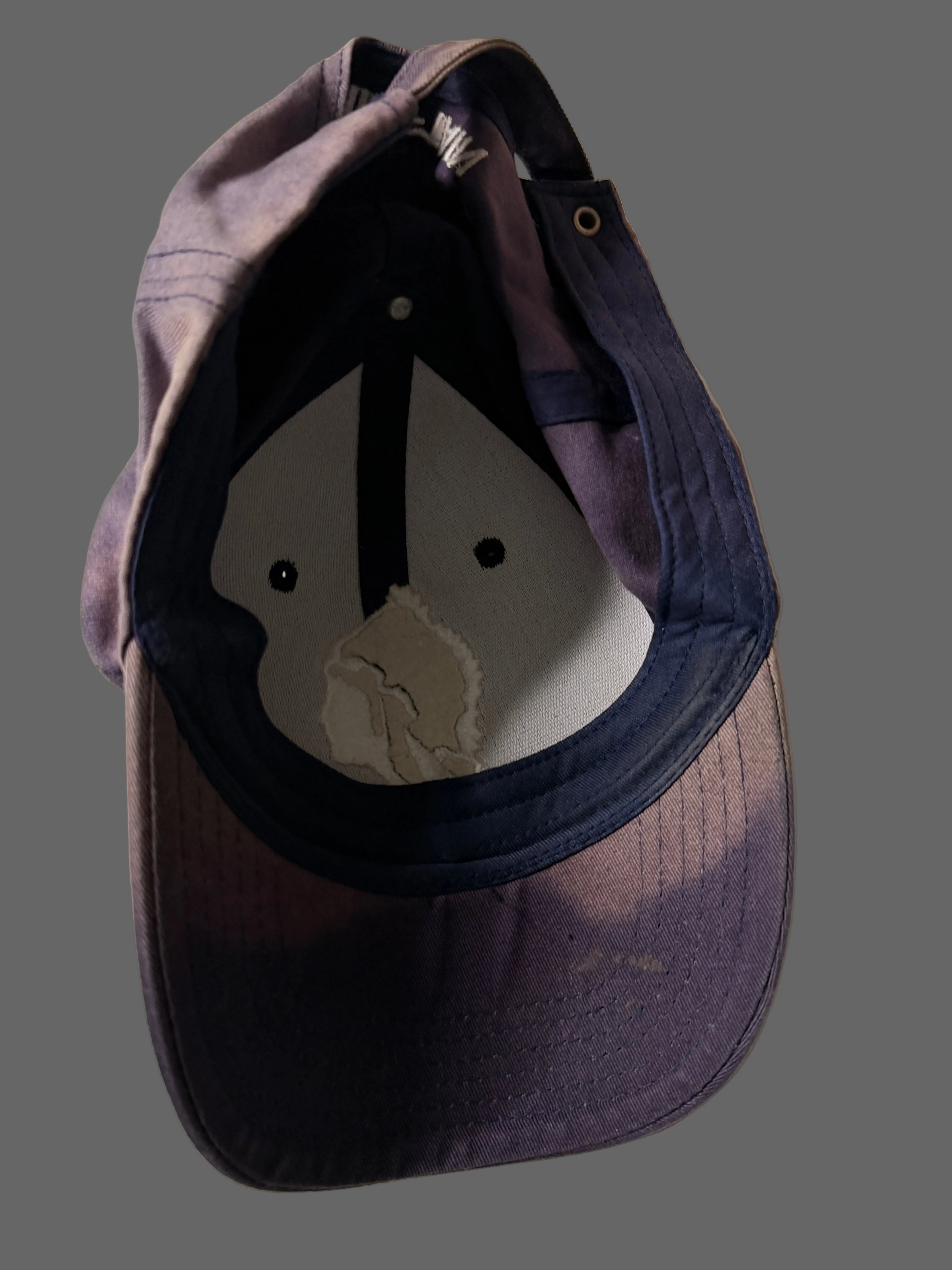 Blue baseball cap with a logo on a white background