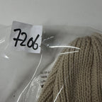 Ball of yarn in clear packaging with a label on a white background