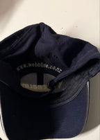 Navy blue cap with visible branding on a light background
