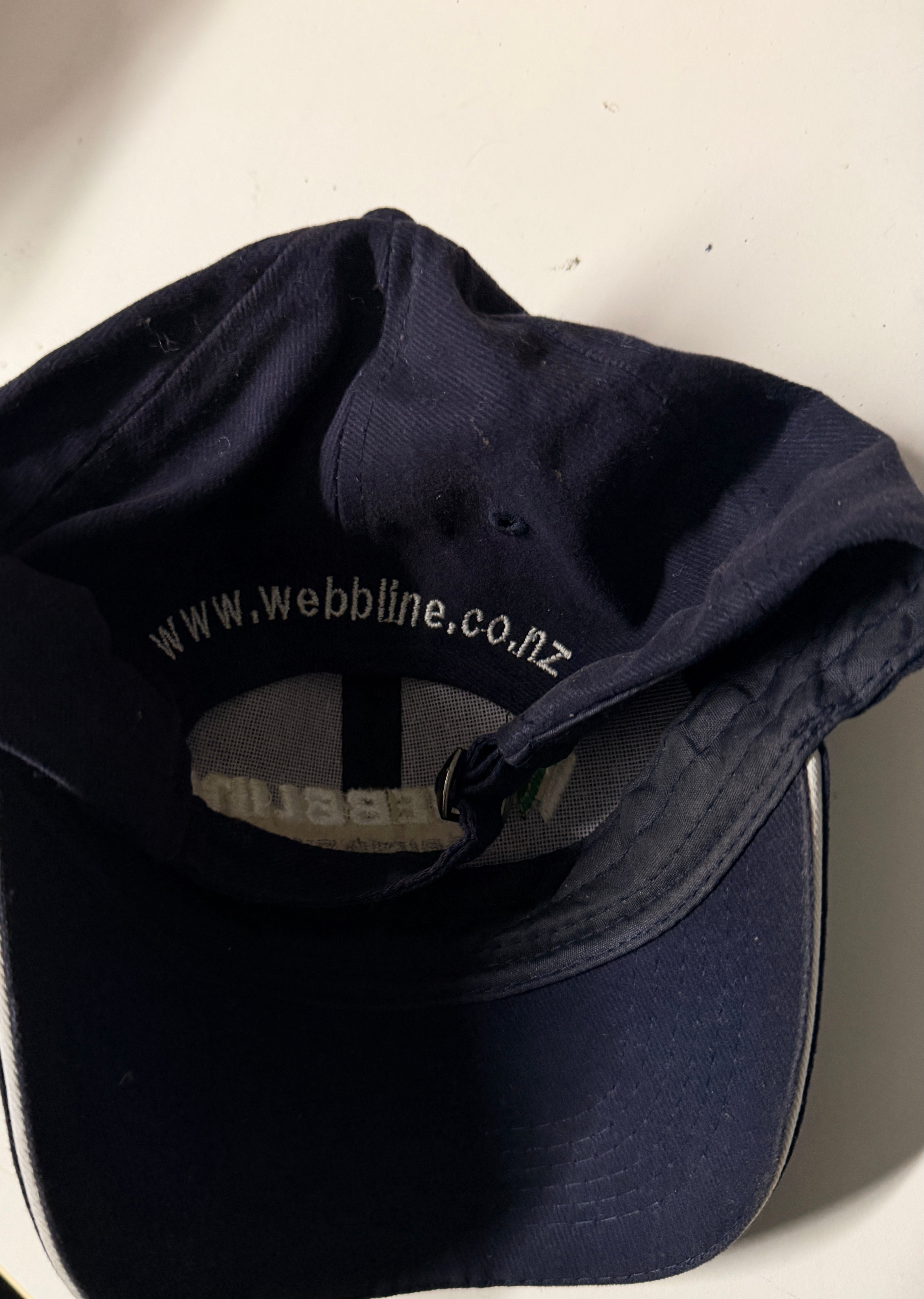 Navy blue cap with visible branding on a light background
