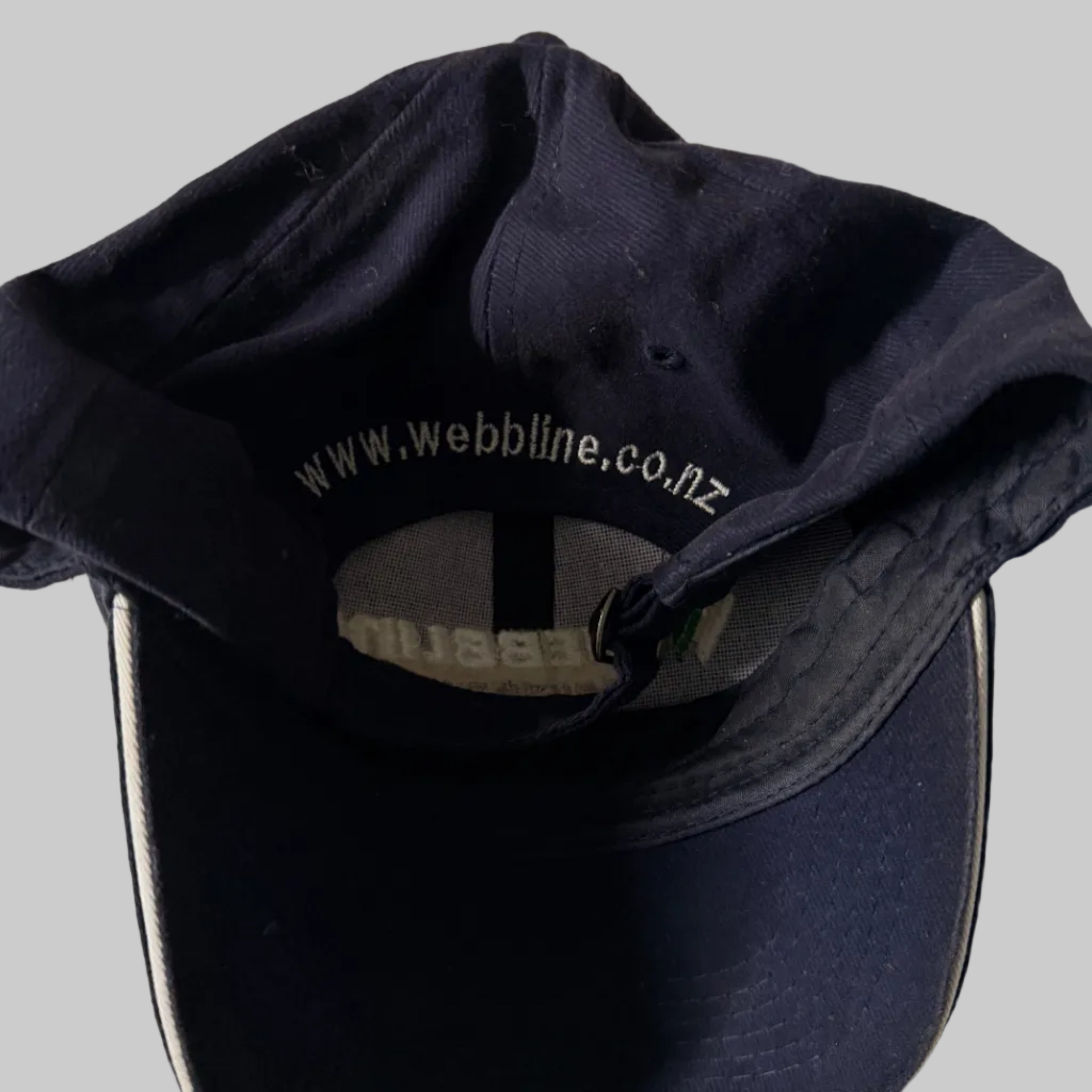 Navy blue cap with visible branding on a light background