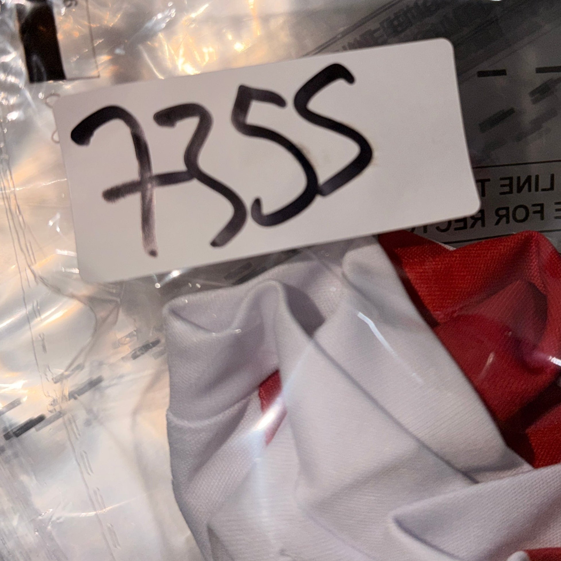 Close-up of a label with the number 7355 on a transparent background