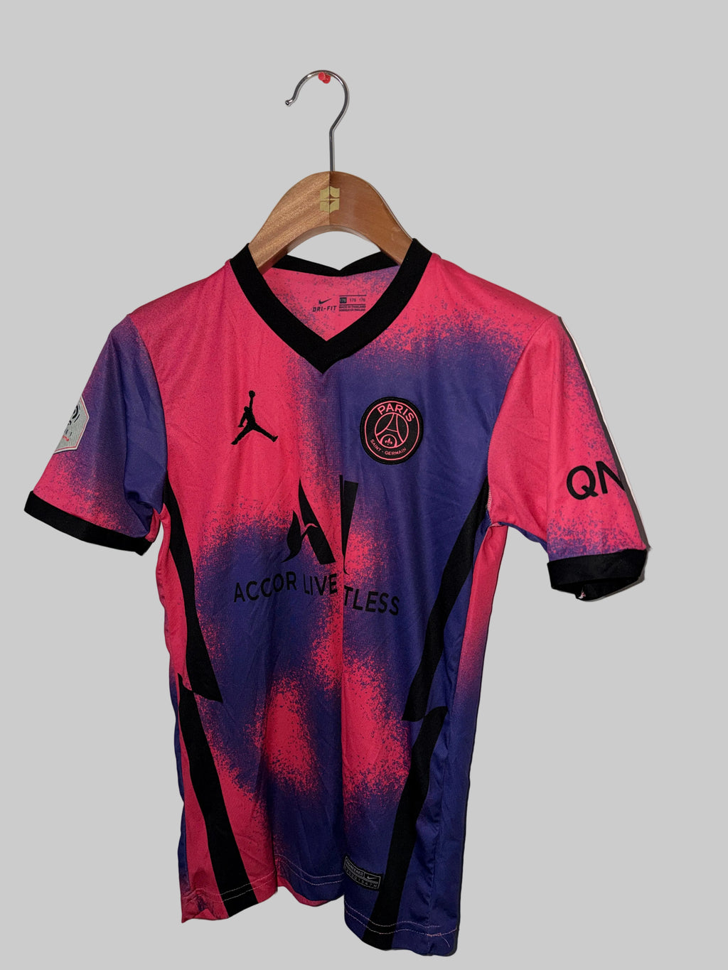 Pink and blue sports jersey with black accents on a white background