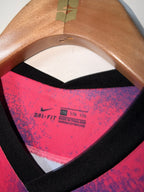 Close-up of a pink and black athletic shoe sole with 'Dri-FIT' label.