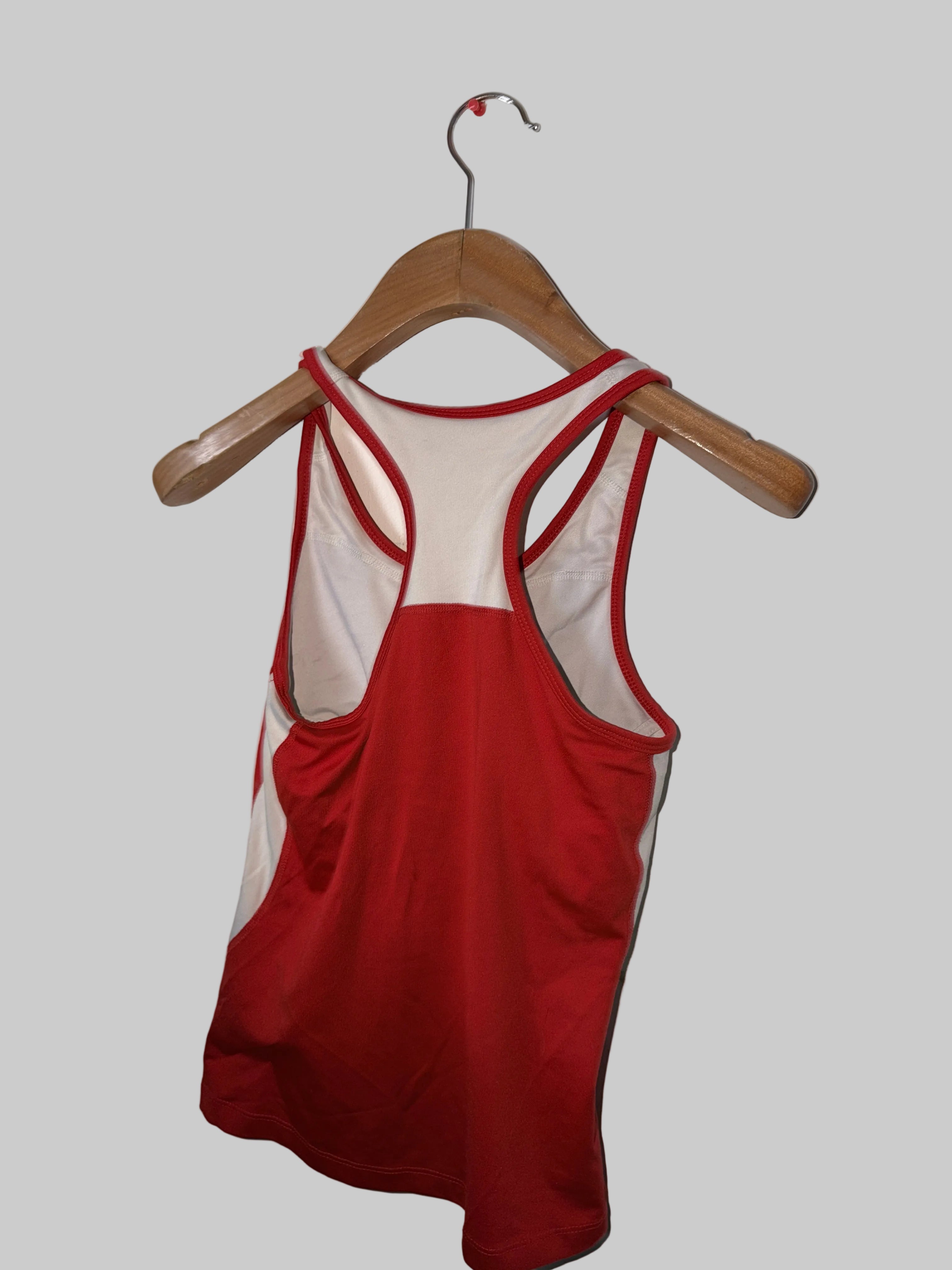 Red swimsuit on a wooden hanger against a white background
