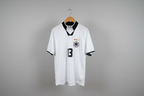 White soccer jersey with black accents on a hanger against a gray background