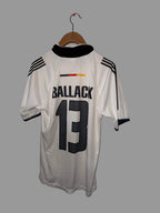 White sports jersey with black text and numbers on a white floor.