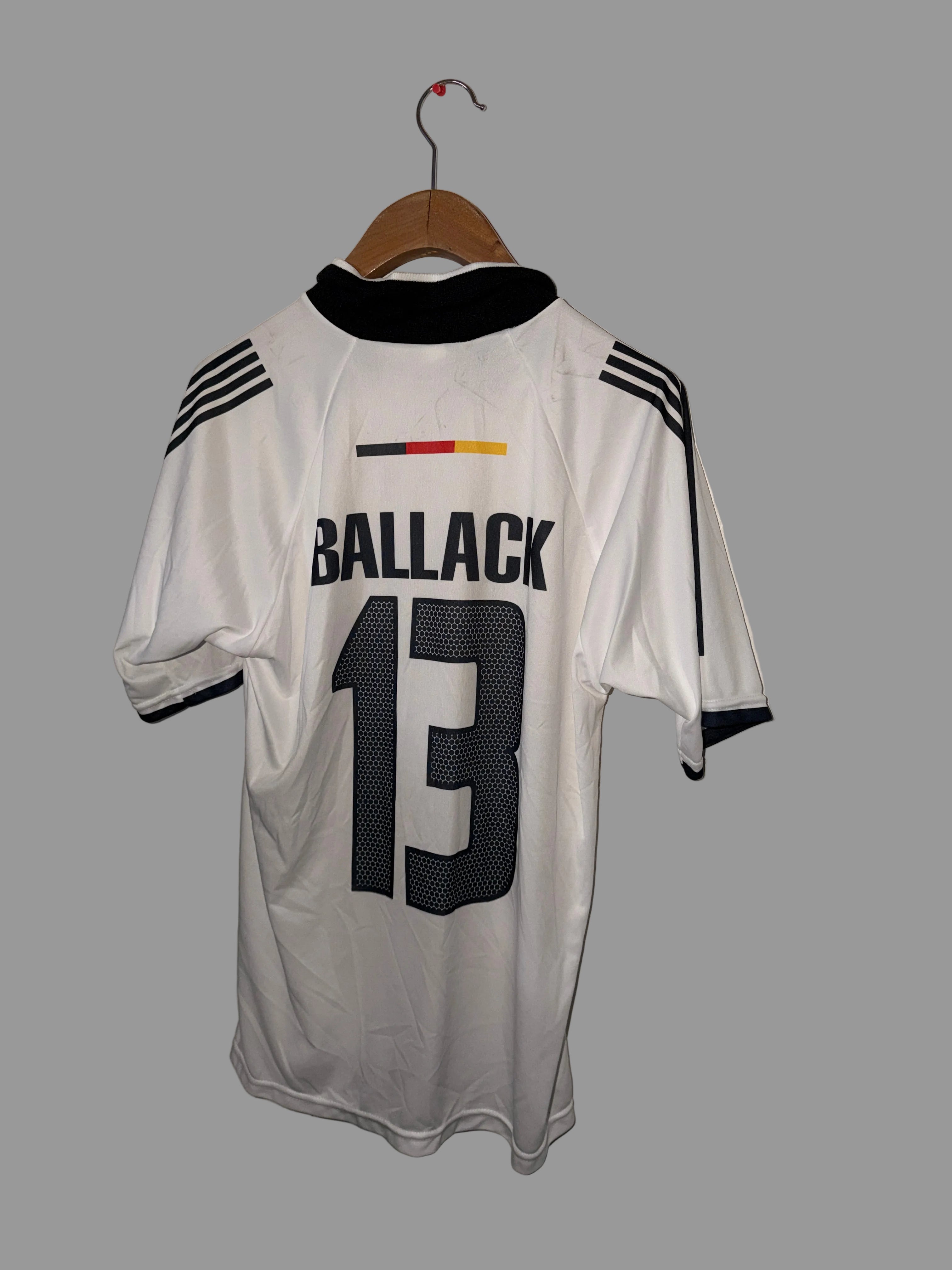 White sports jersey with black text and numbers on a white floor.