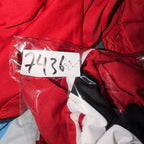 Red jacket with a clear plastic bag containing a white tag with numbers on a red background