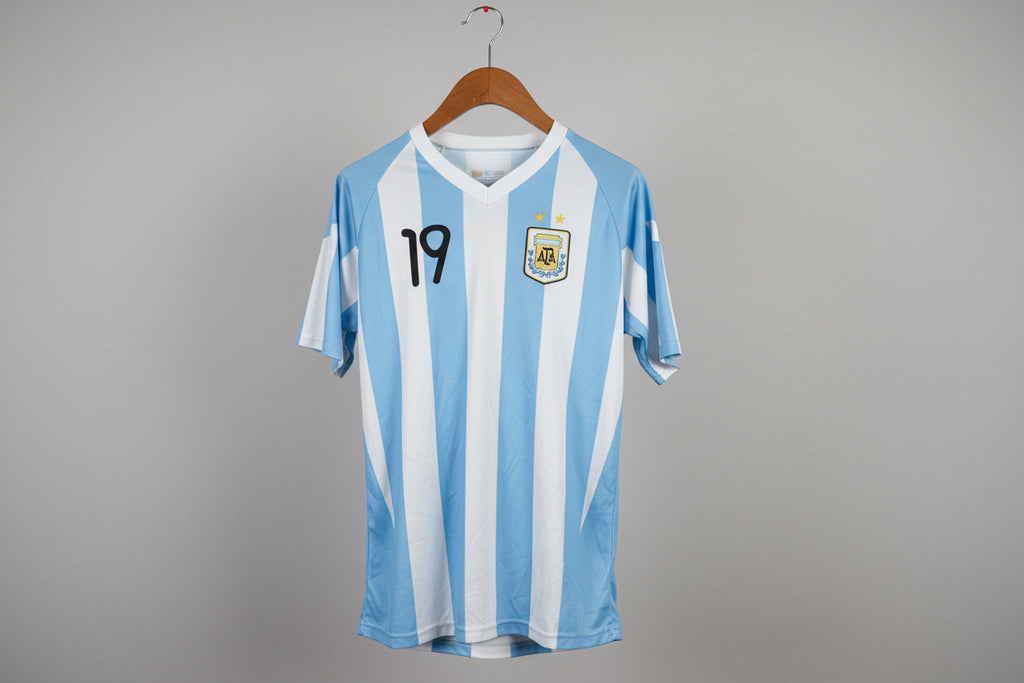 Blue and white striped sports jersey with number 19 on a hanger against a white wall.