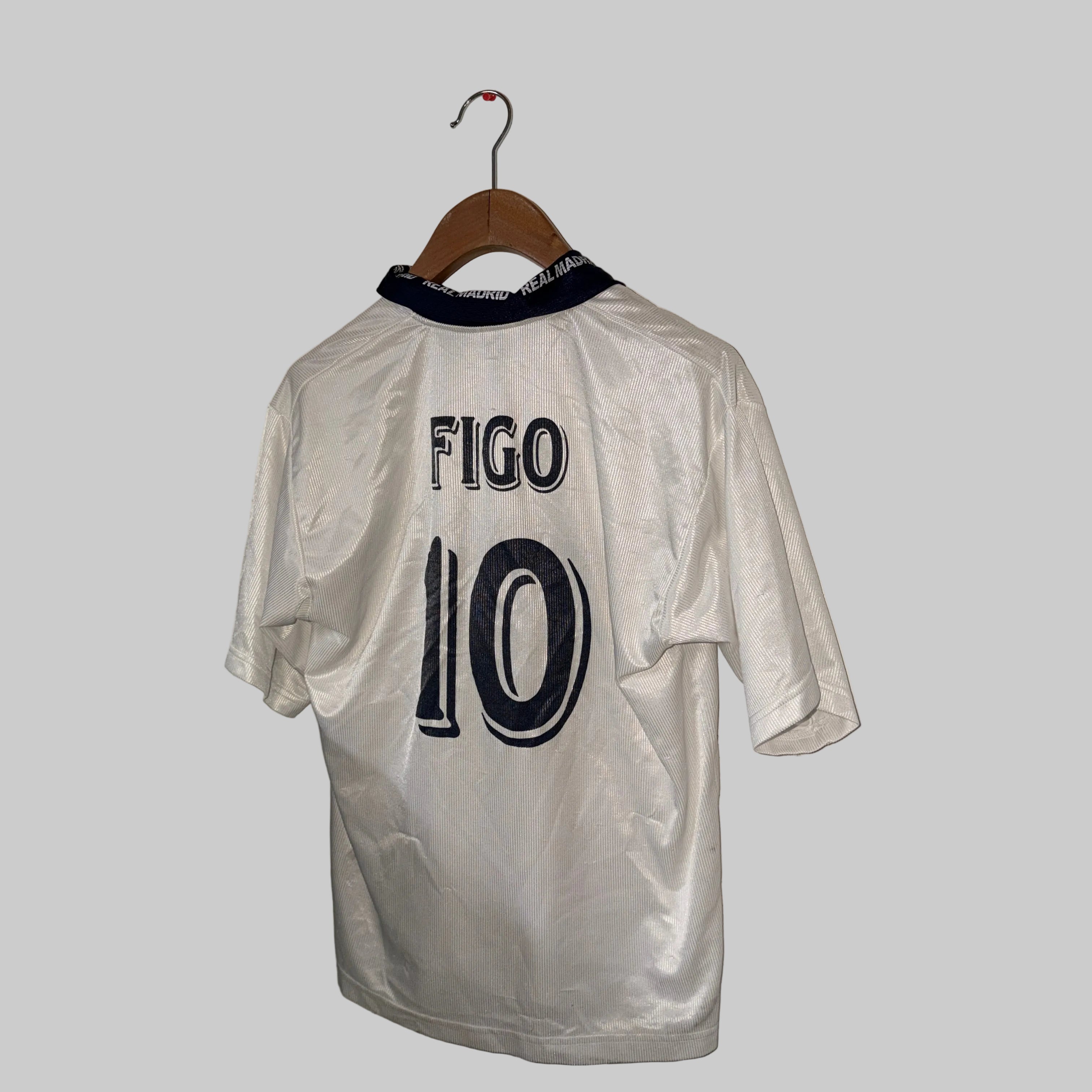 White sports jersey with 'Figo 10' printed on it, hanging on a wooden hanger against a white wall.