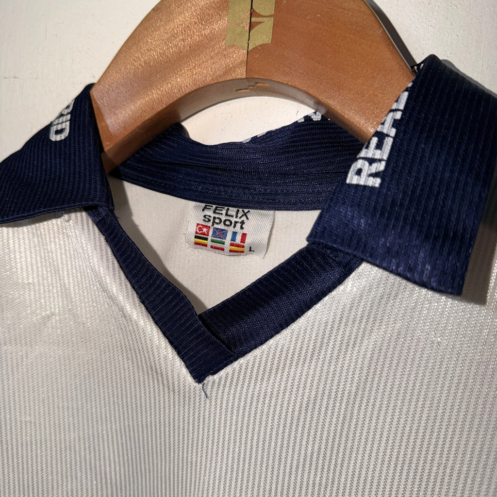 Navy blue sports jacket with visible brand label on a textured surface