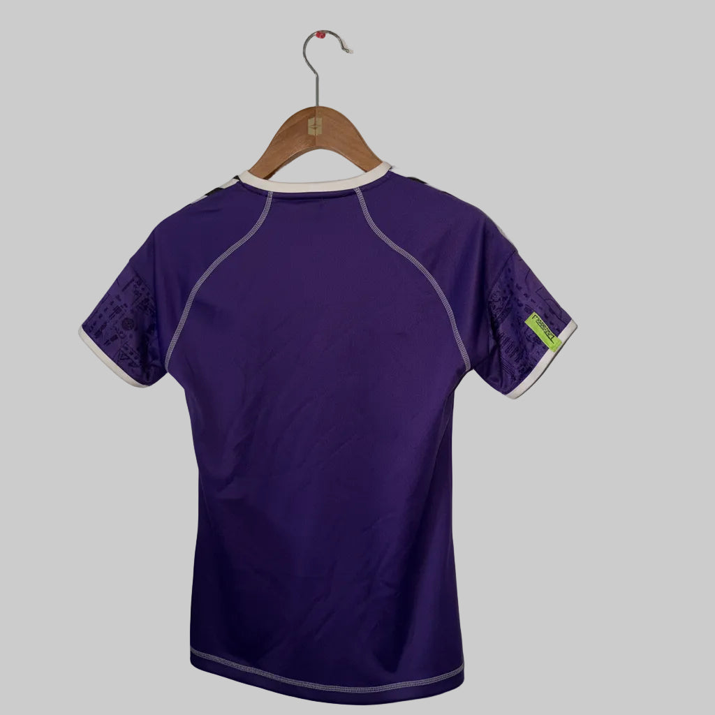 Purple short-sleeve shirt on a hanger against a white wall.
