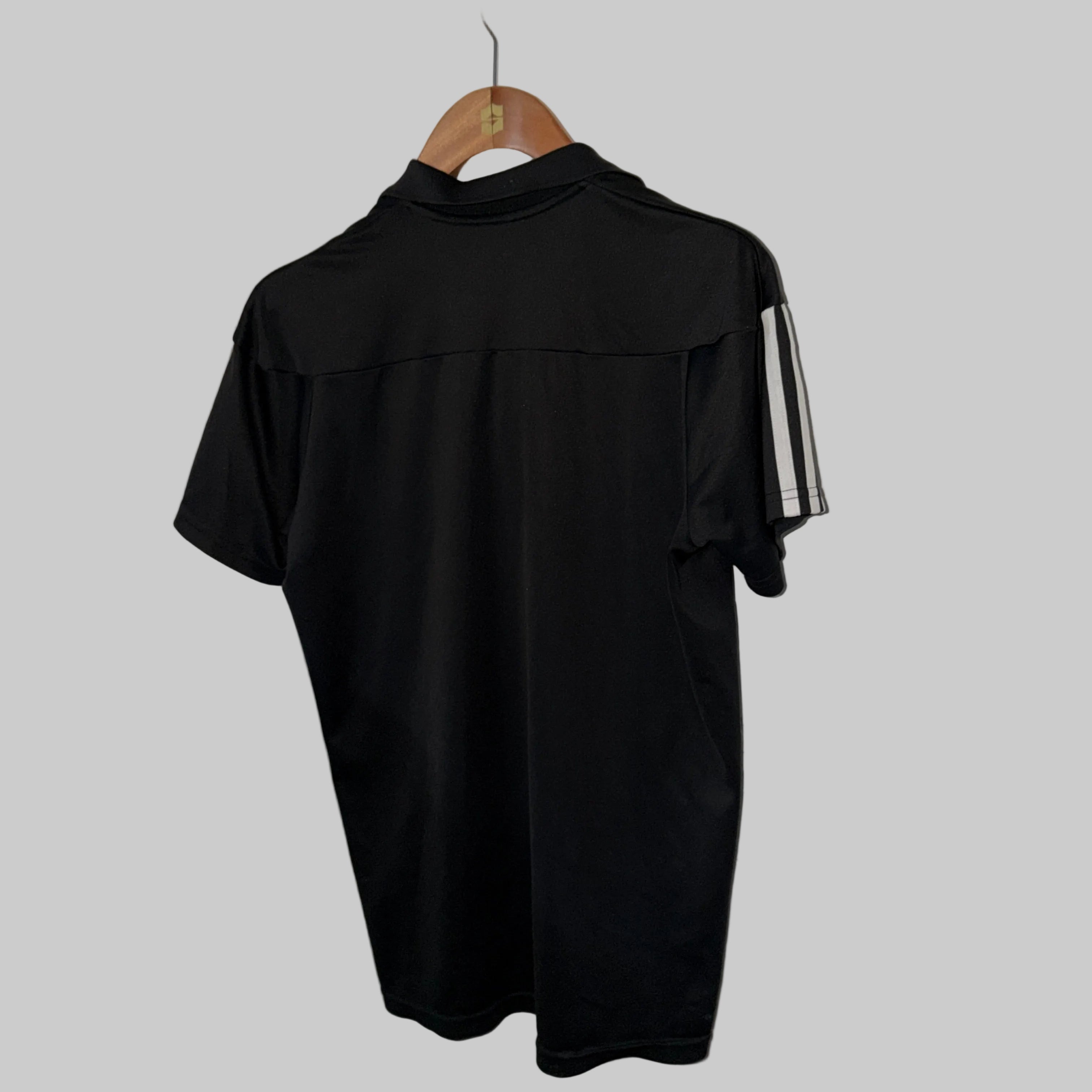 Adidas-branded black polo shirt with Climalite technology and shoulder stripes, similar to the Adidas Men’s Fab Polo Shirt. 7450