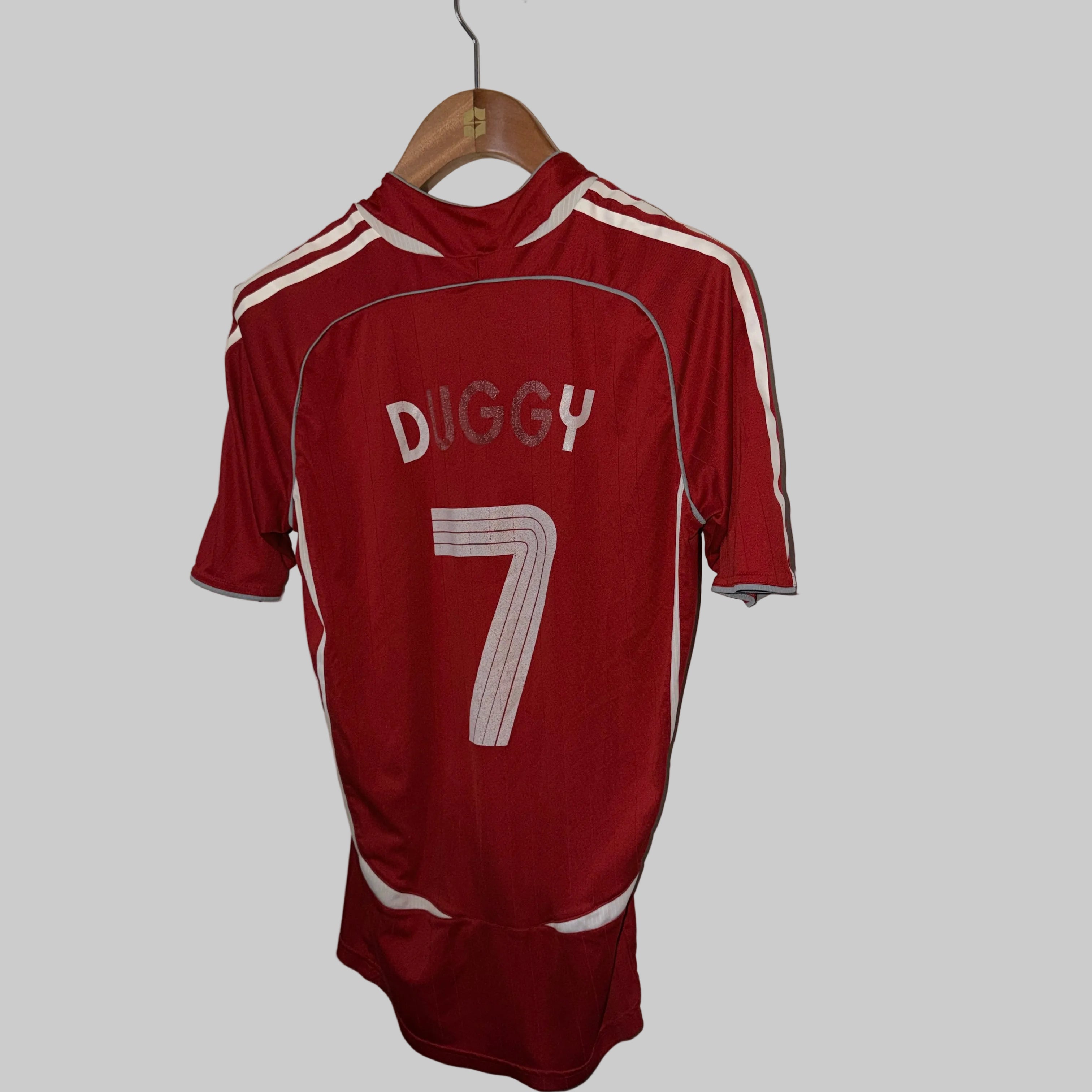 Red sports jersey with 'DIGGY' and number '7' on a hanger against a white wall.