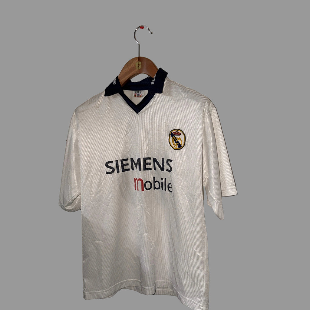 White sports jersey with Siemens and mobile logos on a wooden hanger against a white wall.