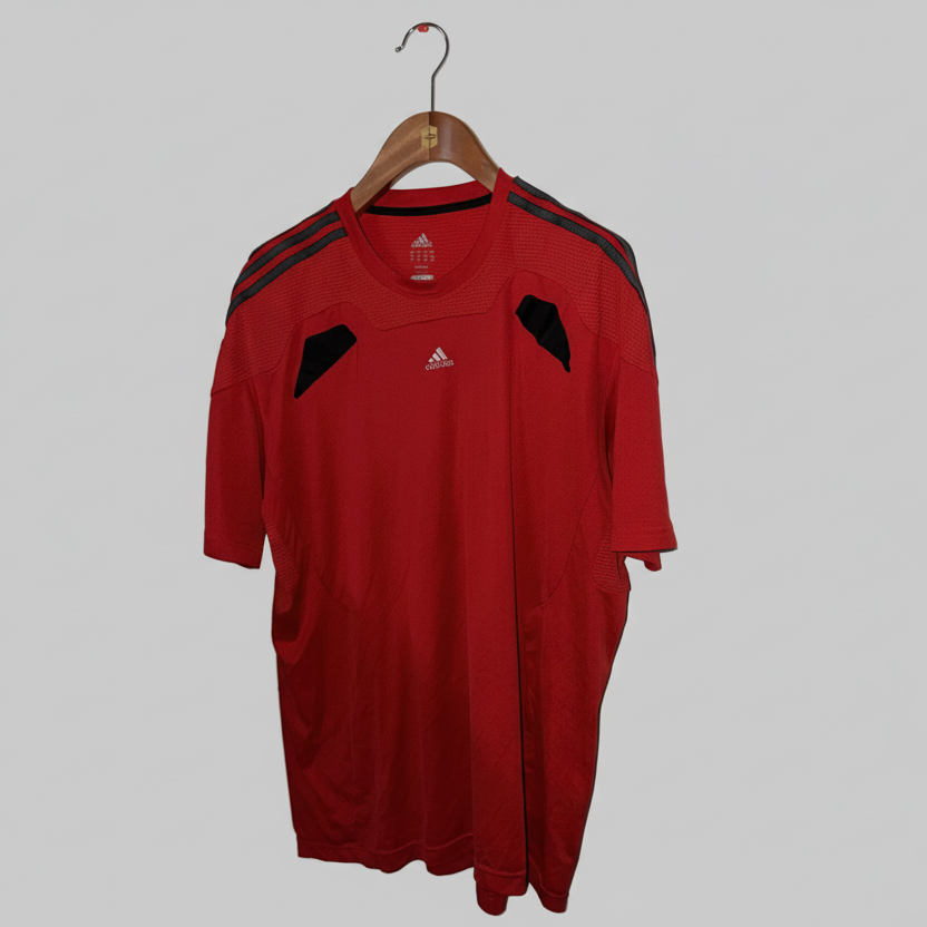 Red sports jersey with black accents on a hanger against a gray background