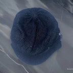 Vintage black lined knitted beanie hat with studded crest