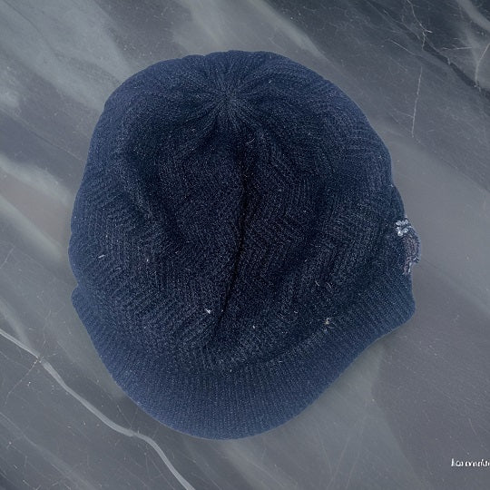 Vintage black lined knitted beanie hat with studded crest