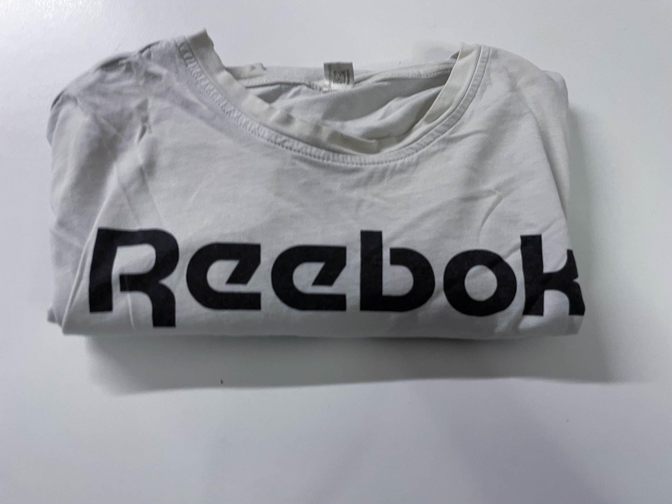 Vintage Men's Reebok print white short sleeve tees in M|L28 W20| SKU 4138