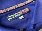 Vintage Men's Reebok Athletics Dept. Blue stripe polo shirt in M|L28 W20|SKU 4140