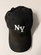 Black cap with 'NY' logo on a white background