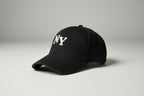 Black cap with 'NY' logo on a gray background