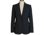 A black, pinstripe women's blazer hanging on a hanger against a white background.